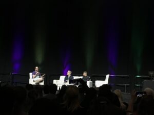 Actors Anthony Rapp and Wilson Cruz sit on couch during a moderated conversation at AwesomeCon 2022.